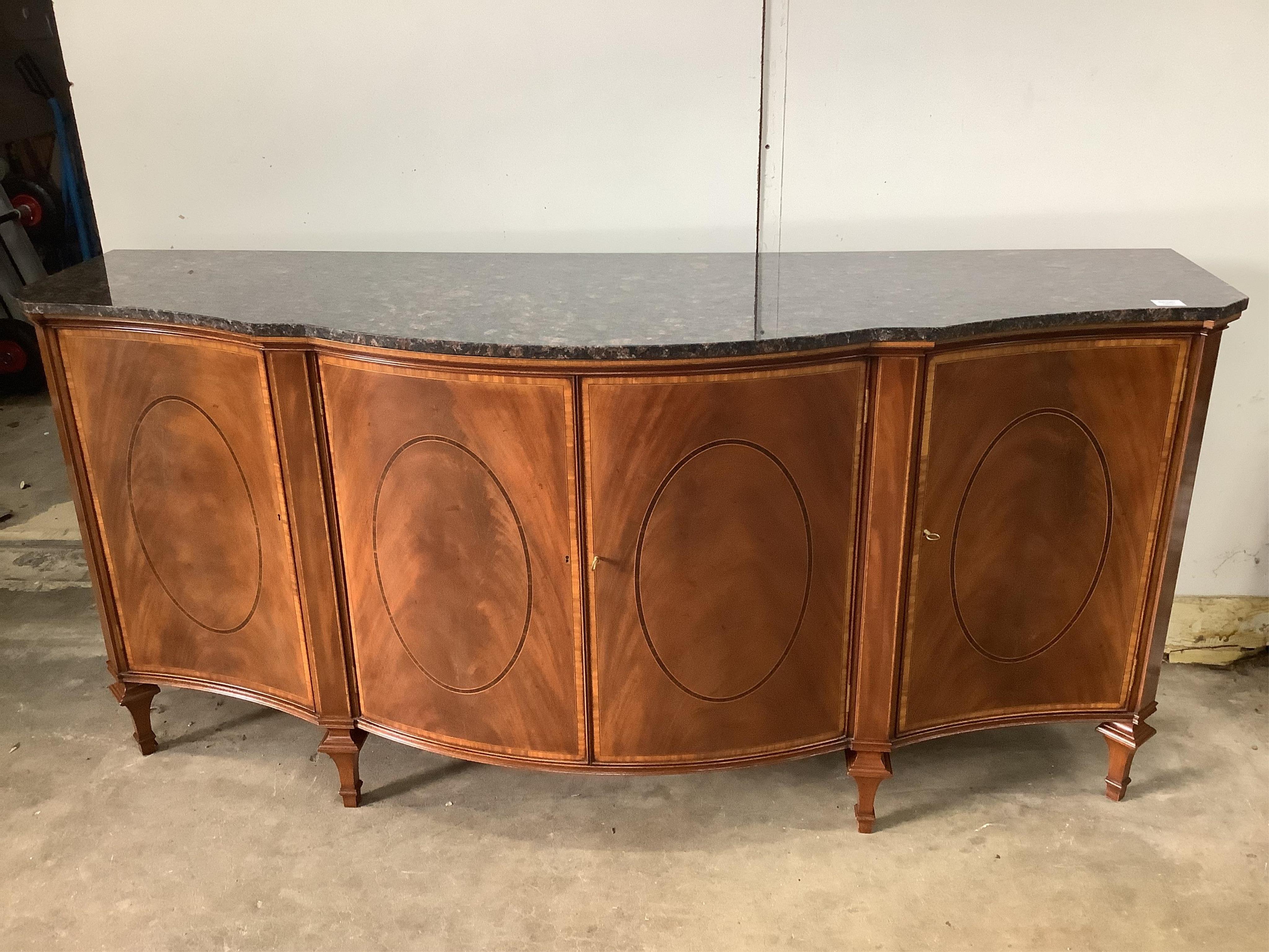 A reproduction marble top serpentine mahogany sideboard, width 181cm, depth 60cm, height 90cm. Condition - good